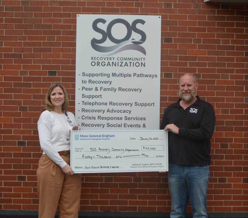 Wentworth-Douglass Hospital has awarded a $40,000 grant to SOS Recovery Community Organization, to assist in expanding access to treatment for substance misuse. From left to right are Michelle Hanson and John Burns.