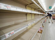 A man shops near empty shelves at a supermarket in Tateyama, Chiba prefecture, near Tokyo as Typhoon Hagibis approaches Friday, Oct. 11, 2019. A powerful typhoon is forecast to bring up to 80 centimeters (31 inches) of rain and damaging winds to the Tokyo area and Japan's Pacific coast this weekend, and the government is warning residents to stockpile necessities and leave high-risk places before it's too dangerous. (Naoya Osato/Kyodo News via AP)