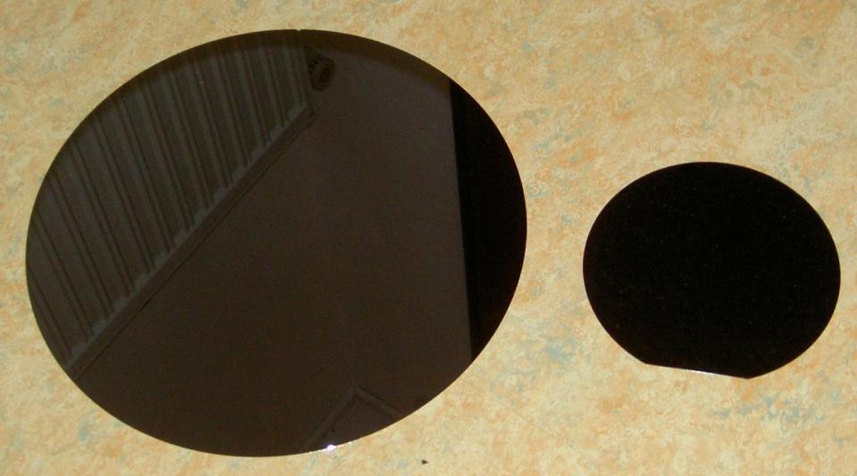 Thin, round slices of silicon crystals, called wafers, are the starting point for most semiconductor chips. <a href="https://commons.wikimedia.org/wiki/File:Siliziumwafer.JPG#/media/File:Siliziumwafer.JPG" rel="nofollow noopener" target="_blank" data-ylk="slk:Hebbe/Wikimedia Commons;elm:context_link;itc:0" class="link ">Hebbe/Wikimedia Commons</a>