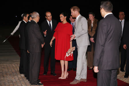 Britain's Prince Harry and Meghan, Duchess of Sussex, are welcomed by officials at the Casablanca Airport in Casablanca, Morocco, February 23, 2019. REUTERS/Hannah McKay/Pool