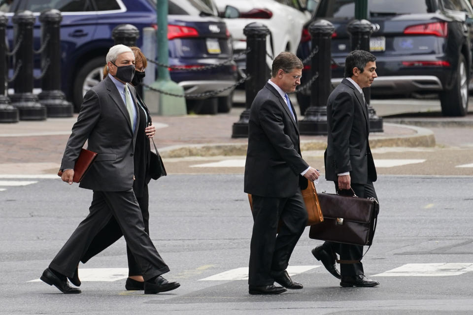 Former Penn State President Graham Spanier, left, walks to his hearing at the Dauphin County Courthouse in Harrisburg, Pa., Wednesday, May 26, 2021. A judge will determine if and when Spanier must report to jail to begin serving time for a single misdemeanor conviction of endangering the welfare of children. (AP Photo/Matt Rourke)