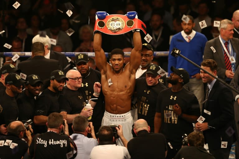 British boxer Anthony Joshua celebrates beating US boxer Charles Martin (not pictured) following their IBF World Heavyweight title boxing match at the O2 arena in London on April 9, 2016