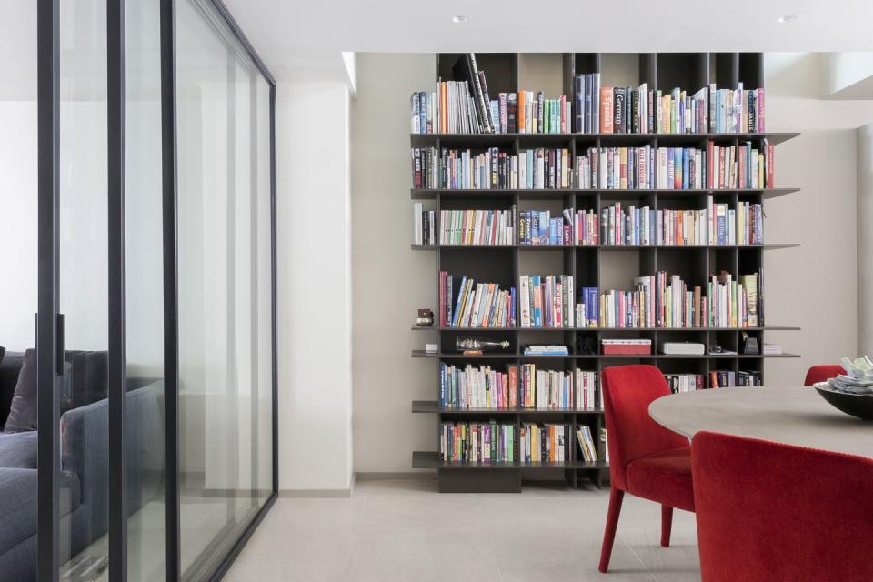 a room with a bookcase and chairs