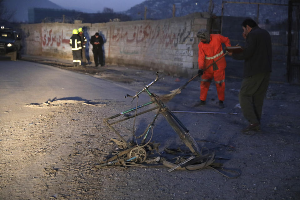 Afghan security personnel inspect the site of a bomb attack in Kabul, Afghanistan, Monday, Dec. 28, 2020. In two explosions Monday in the capital Kabul, multiple people were wounded, according to Kabul police. (AP Photo/Rahmat Gul)