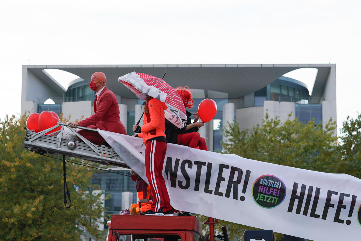 Berlin: Künstler stehen bei der Großdemonstration des Aktionsbündnis #AlarmstufeRot zur Existenznot der Veranstaltungswirtschaft in der Corona-Krise auf einem Leiterwagen vor dem Kanzleramt. (Bild: Jörg Carstensen/dpa)