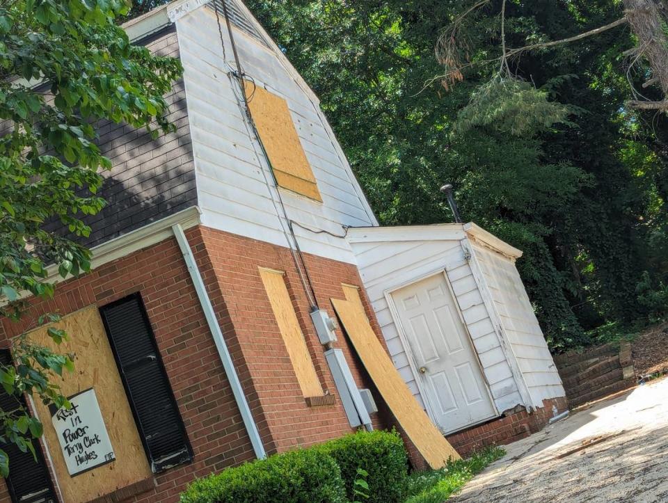 The white plank siding is pockmarked with bullet holes on the boarded-up house at 5525 Galway Drive in Charlotte shows bullet holes on May 21, 2024.