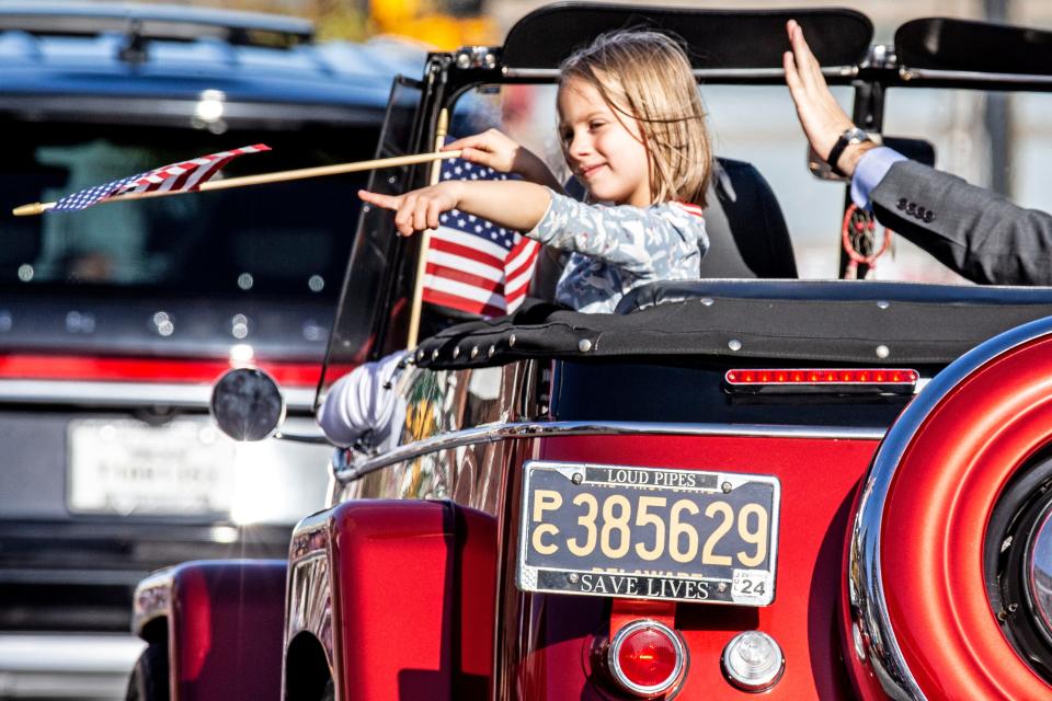 A young participant greets the crowd from a vintage convertible during the Return Day parade at The Circle in Georgetown, Del., Thursday, Nov. 10, 2022.