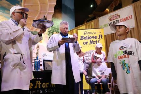 Vito Mendez from White Sands Missile Range, New Mexico, stands while his shoe is judged during the Odor-Eater's Rotten Sneaker Contest at Ripley's Believe It or Not! Times Square in New York, U.S., March 28, 2017. REUTERS/Shannon Stapleton