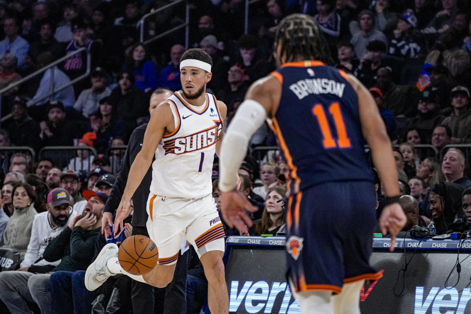 Phoenix Suns guard Devin Booker (1) advances the ball during the first half of an NBA basketball game against the New York Knicks in New York, Sunday, Nov. 26, 2023. (AP Photo/Peter K. Afriyie)