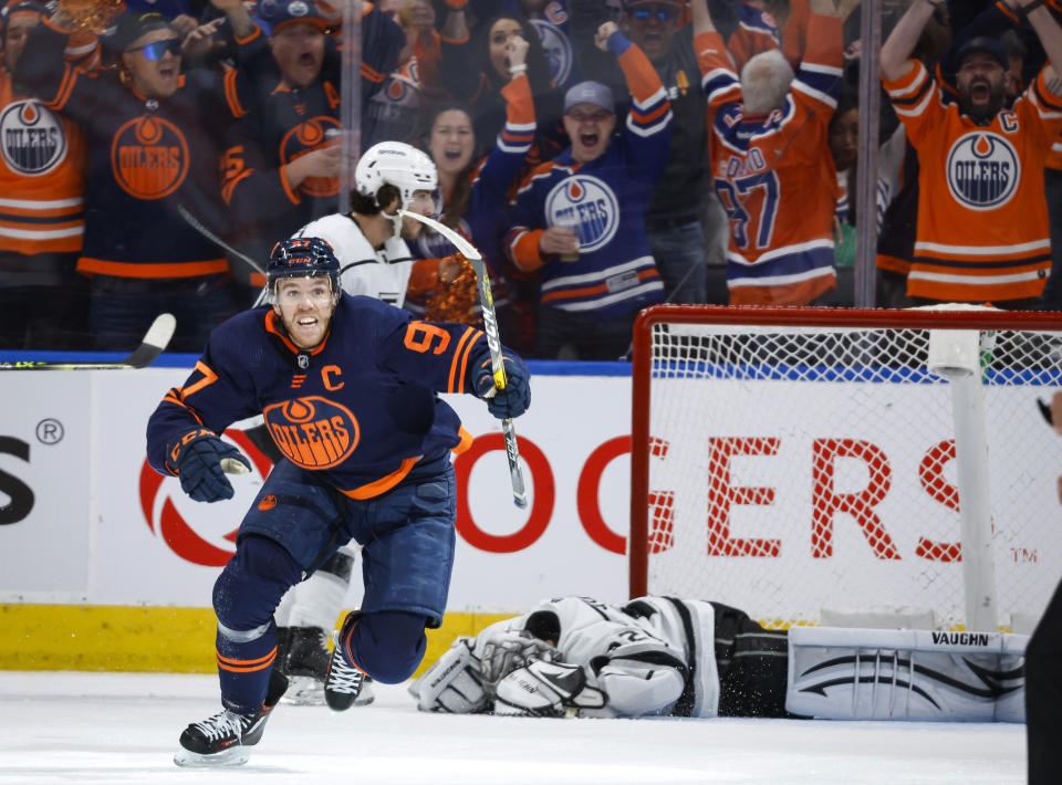 Los Angeles Kings goalie Jonathan Quick, right, lies on the ice as Edmonton Oilers center Connor McDavid celebrates his goal during the third period in Game 7 of a first-round series in the NHL hockey Stanley Cup playoffs Saturday, May 14, 2022, in Edmonton, Alberta. (Jeff McIntosh/The Canadian Press via AP)