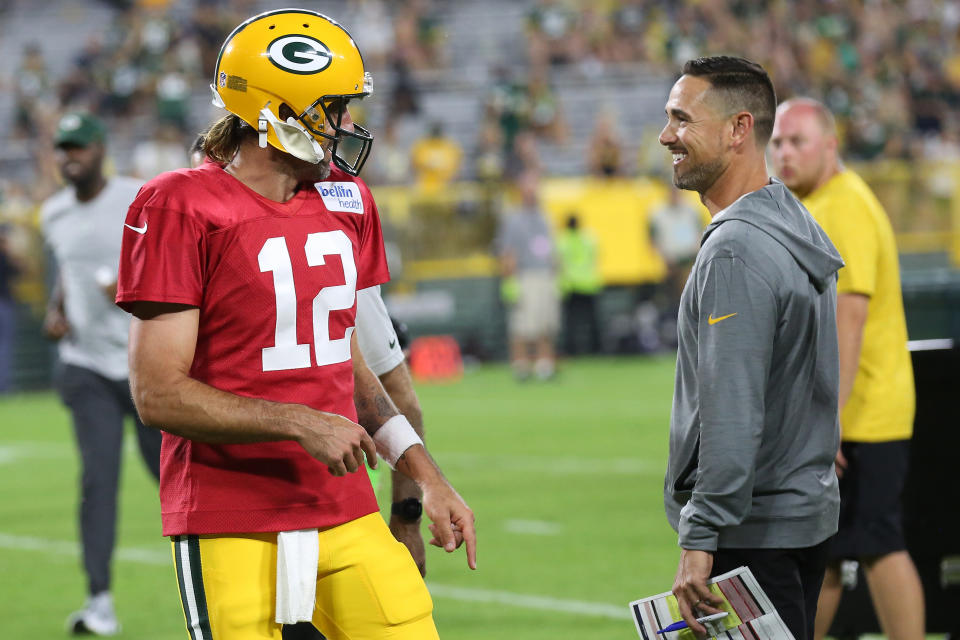 ASHWAUBENON, WI - AUGUST 05: Green Bay Packers quarterback Aaron Rodgers (12) and Green Bay Packers head coach Matt LaFluer share a laugh during Green Bay Packers Family Night at Lambeau Field, on August 5, 2022 in Green Bay, WI. (Photo by Larry Radloff/Icon Sportswire via Getty Images)