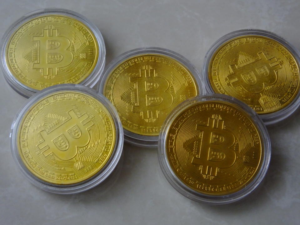 A group of commemorative bitcoin coins.