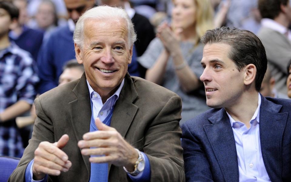 In this Jan. 30, 2010, file photo, Vice President Joe Biden, left, with his son Hunter, right, at the Duke Georgetown NCAA college basketball game in Washington. - Nick Wass/AP