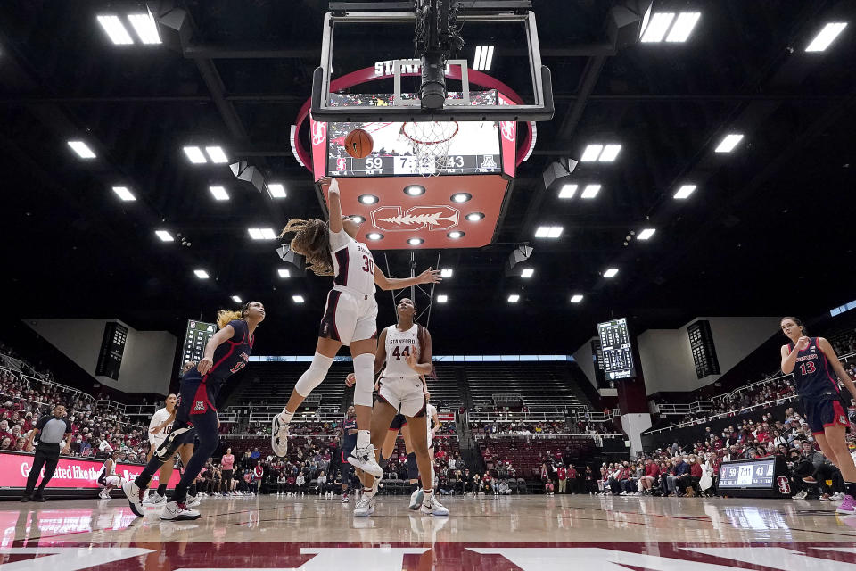 Stanford guard Haley Jones (30) drives to the basket against Arizona forward Esmery Martinez, left, during the second half of an NCAA college basketball game Monday, Jan. 2, 2023, in Stanford, Calif. (AP Photo/Tony Avelar)