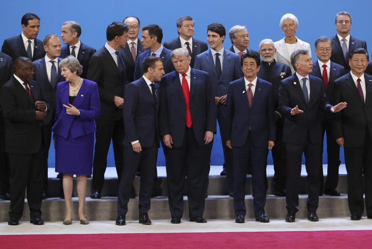 President Donald Trump, front center, listens to France’s President Emmanuel Macron as they pose with world leaders for a group picture at the start of the G-20 Leader’s Summit inside the Costa Salguero Center in Buenos Aires, Argentina, Friday, Nov. 30, 2018. Bottom row from left are South Africa’s President Cyril Ramaphosa, Britain’s Prime Minister Theresa May, Japan’s Prime Minister Shinzo Abe, Argentina’s President Mauricio Macri and China’s President Xi Jinping. Middle row, from left, are European Council’s President Donald Tusk, the Netherlands’ Prime Minister Mark Rutte, Spain’s Prime Minister Pedro Sanchez, France’s President Emmanuel Macron, India’s Prime Minister Narendra Modi and South Korea’s President Moon Jae-in. International Monetary Fund Managing Director Christine Lagarde stands in the top row, second from right. (Photo: Ricardo Mazalan/AP)