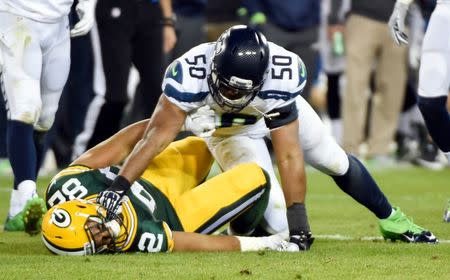 Seattle Seahawks linebacker K.J. Wright (50) hits Green Bay Packers tight end Richard Rodgers (82) after a play in the fourth quarter at Lambeau Field. Wright was ejected from the game. Sep 20, 2015; Green Bay, WI, USA. Benny Sieu-USA TODAY Sports