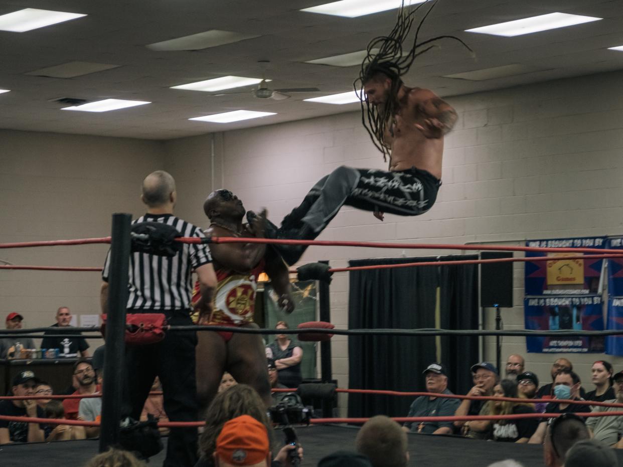 Madman Fulton lands a top-rope dropkick to Shogun Jackson Stones' face during the Insane Wrestling Revolution’s IWR 12 - Clash of the Titans June 9 at the Monroe FOP Lodge.