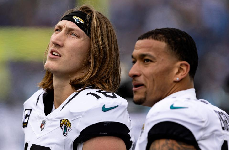 Jacksonville Jaguars quarterback Trevor Lawrence (16) and tight end Evan Engram (17) watch the Jumbotron as they take a break during their NFL football game against the Tennessee Titans Sunday, Jan. 7, 2024, in Nashville, Tenn. (AP Photo/Wade Payne)