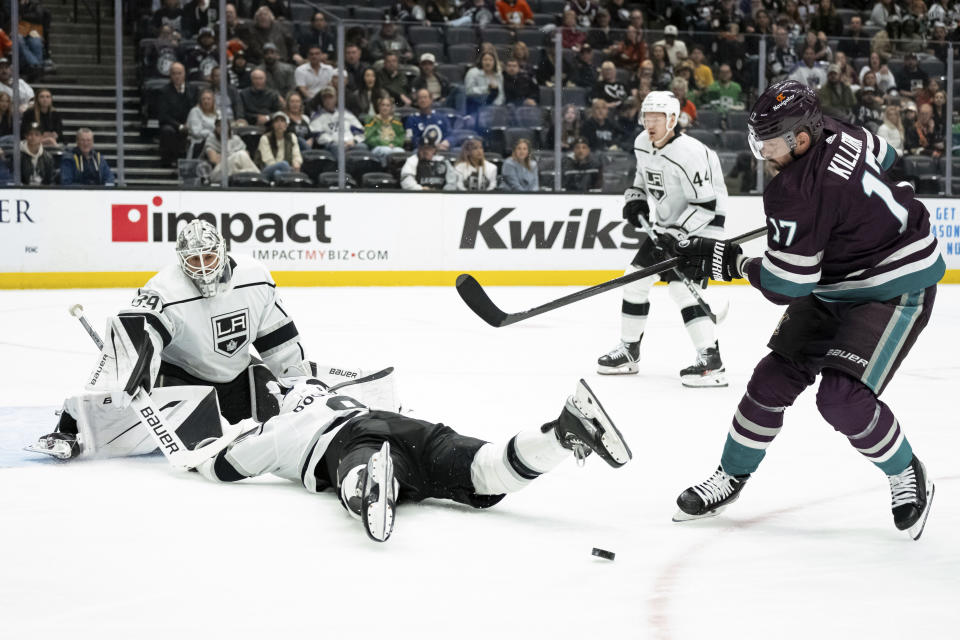 Los Angeles Kings defenseman Drew Doughty, bottom, blocks a shot by Anaheim Ducks left wing Alex Killorn (17) during the first period of an NHL hockey game Tuesday, April 9, 2024, in Anaheim, Calif. (AP Photo/William Liang)
