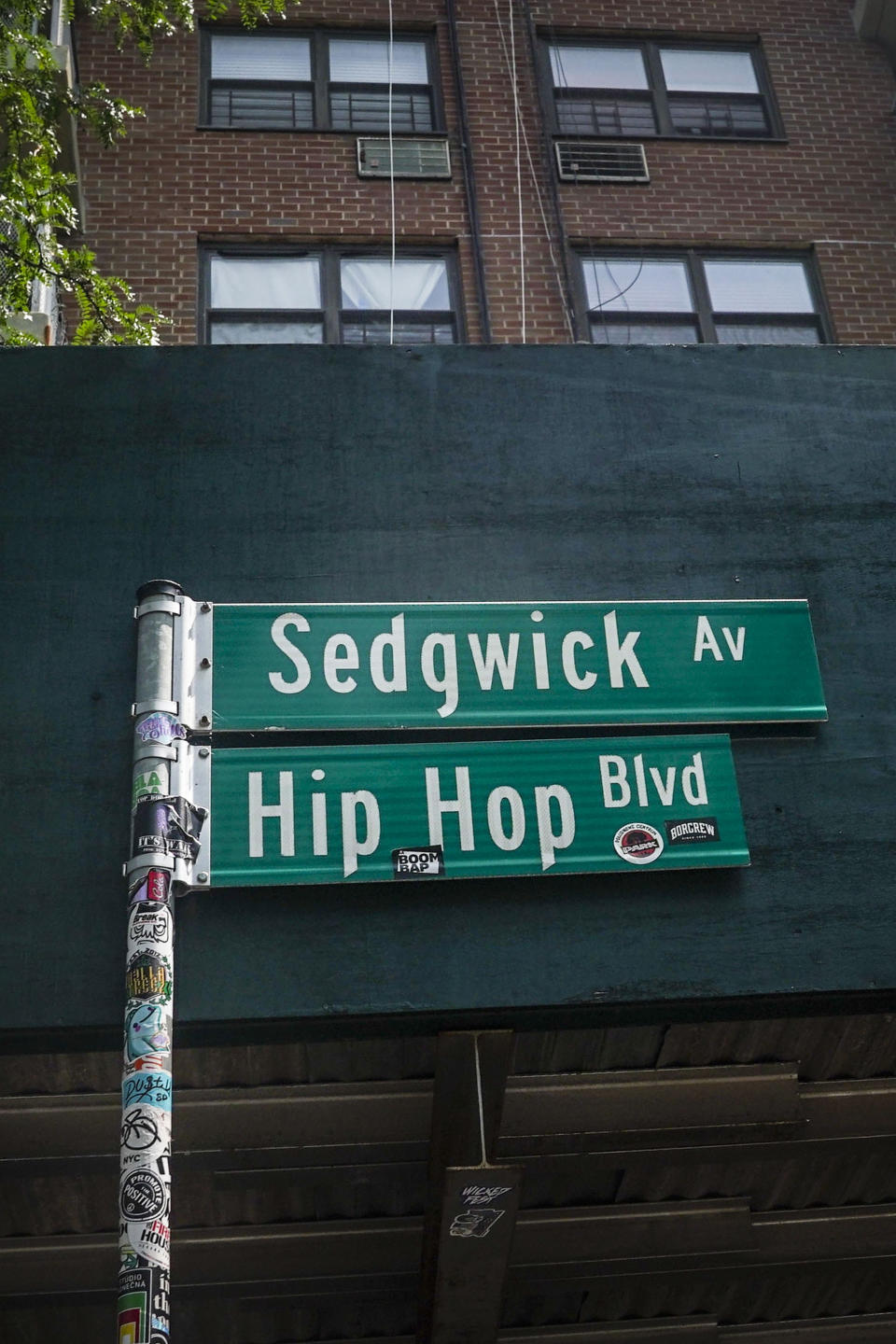 A street sign at Bronx's Sedgwick Houses apartments is shown renamed as Hip Hop Blvd, recognizing the site where hip hop's creator DJ Kool Herc first held parties featuring his new sound, July 26, 2023, in New York. In the five decades since hip-hop emerged out of New York City, it has spread around the country and the world. And at each step there's been change and adaptation, as new, different voices came in and made it their own. Its foundations are steeped in the Black communities where it first made itself known but it's spread out until there’s no corner of the world that hasn’t been touched by it. Hip-hop has impacted everything: Art, culture, fashion, community, social justice, politics, sports, business. This year is being marked as a 50th anniversary celebration. (AP Photo/Bebeto Matthews)