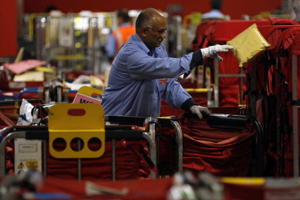 A Royal Mail employee sorts packages at the Royal Mail Mount Pleasant Sorting Office in London May 10, 2012. Britain's Royal Mail said plans to turn over half of its main London sorting office - Mount Pleasant - into a prime residential hub will be submitted next spring, as the group tries to boost its value ahead of a 2014 privatisation. Picture taken May 10, 2012. REUTERS/Stefan Wermuth (BRITAIN - Tags: BUSINESS)