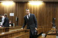 Oscar Pistorius arrives in court on the third day of his trial at the high court in Pretoria, South Africa, Tuesday, March 5, 2014. Pistorius is charged with murder for the shooting death of his girlfriend, Reeva Steenkamp, on Valentine's Day in 2013. (AP Photo/Siphiwe Sibeko, Pool)
