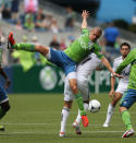 SEATTLE, WA - AUGUST 18: Osvaldo Alonso #6 of the Seattle Sounders FC battles Kenny Miller #7 of the Vancouver Whitecaps at CenturyLink Field on August 18, 2012 in Seattle, Washington. (Photo by Otto Greule Jr/Getty Images)