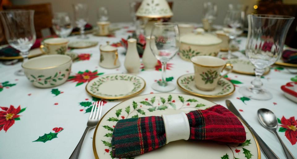 Diane Evans sets out her china for the holidays. It's a  Lenox Christmas pattern with holly and ivy