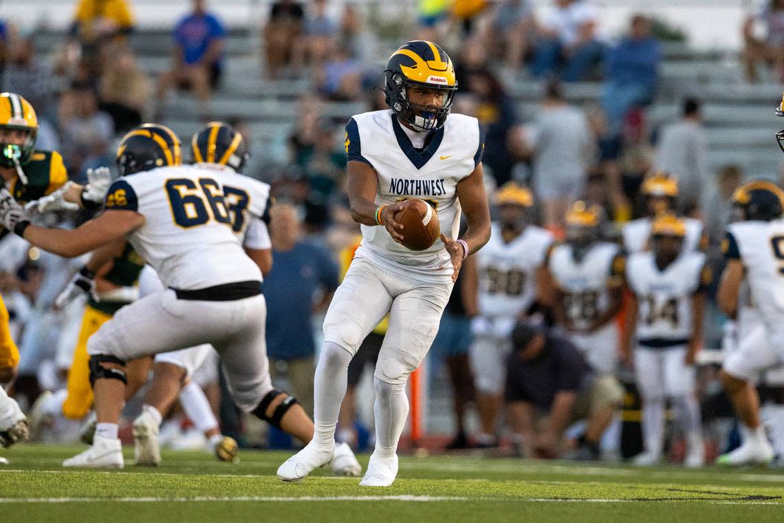 Northwest junior quarterback Jaylen Mason fakes a handoff in Friday’s 34-13 road win over Bishop Carroll.