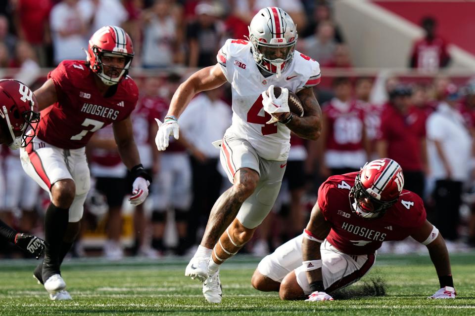 Ohio State receiver Julian Fleming runs past Indiana's Jacob Mangum-Farrar (7) and Anthony Jones (4).