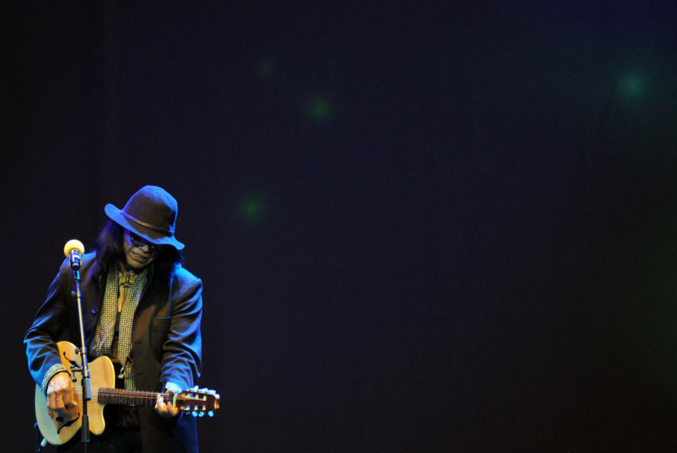 CORRECTS SPELLING OF LOCATION - In this photo taken Tuesday Feb. 12, 2013, Sixto Rodriguez performs on stage at Carnival City, near Johannesburg, South Africa. The heart-warming and inspiring story of how two South Africans seek out the fate of their musical hero is an Oscar-nominated documentary, “Searching for Sugar Man” by Swedish filmmaker Malik Bendjelloul. It’s won several other awards and taken guitarist, singer and song-writer Rodriguez, now half-blind and in his 70s, to New York’s Carnegie Hall and London’s Royal Albert Hall on a worldwide tour including sold-out concerts in the home of his stardom, South Africa. (AP Photo)