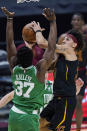 Cleveland Cavaliers' Brodric Thomas, right, drives to the basket against Boston Celtics' Semi Ojeleye during the second half of an NBA basketball game Wednesday, May 12, 2021, in Cleveland. (AP Photo/Tony Dejak)
