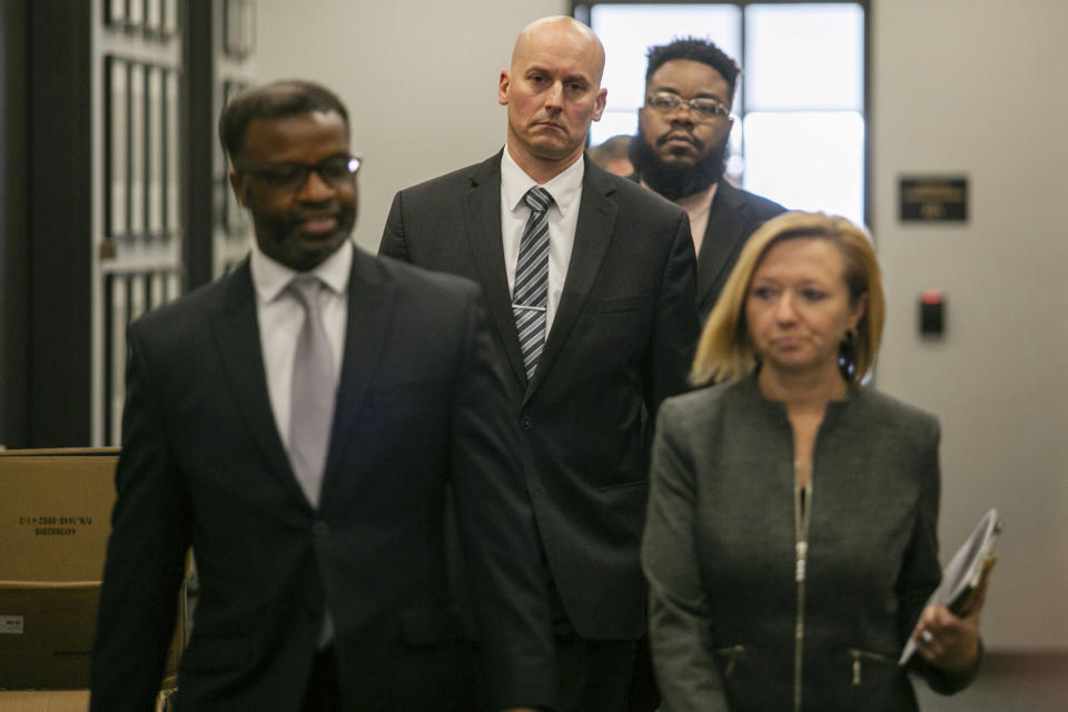 Grand Rapids Mayor Rosalynn Bliss, right to left, Police Chief Eric Winstrom, City Manager Mark Washington and Oversight and Public Accountability Director Brandon Davis walk into a press conference at City Hall Thursday, June 9, 2022 in Grand Rapids, Mich. A prosecutor filed a second-degree murder charge Thursday against the Michigan police officer who killed Patrick Lyoya, a Black man who was on the ground when he was shot in the back of the head following an intense physical struggle recorded on a bystander's phone.. (Daniel Shular/The Grand Rapids Press via AP)