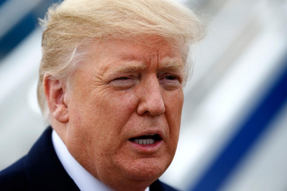 President Donald Trump takes questions from a gathering of reporters next to Air Force One at Lunken Airport in Cincinnati on Friday, Oct. 12, 2018. President Trump visited the Cincinnati area for a MAGA Rally at the Warren County Fair Grounds in Lebanon, Ohio, Friday night.