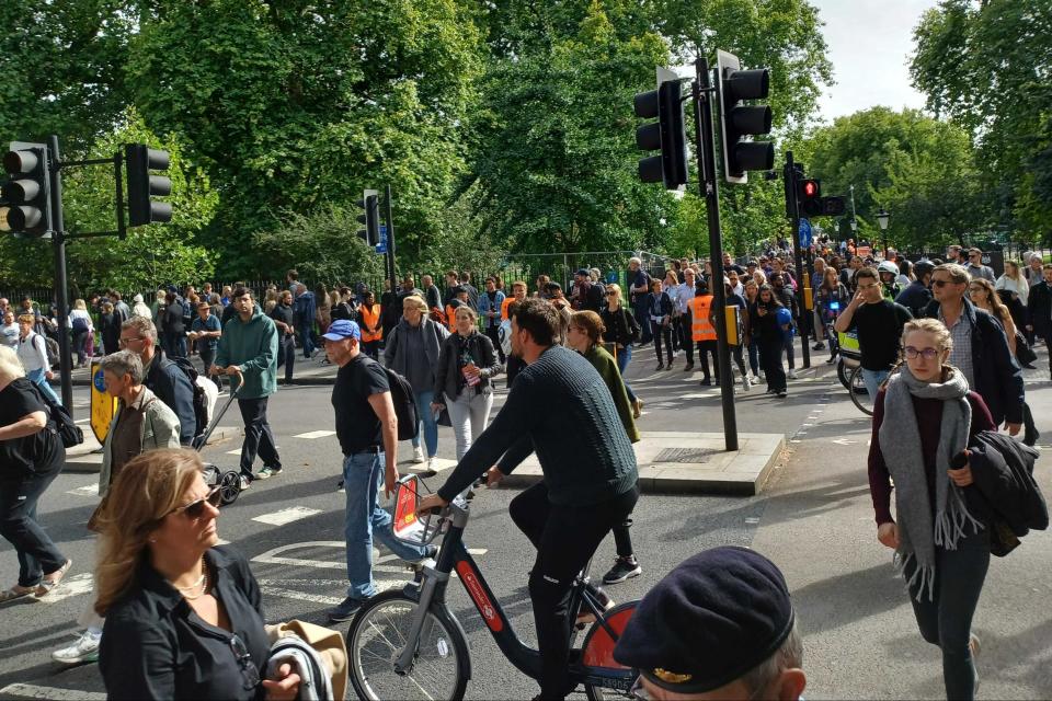 People leaving the park, where the funeral was shown on big screens (ES)