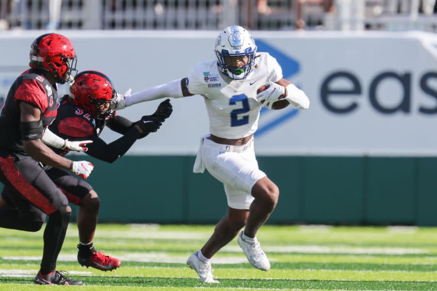 HONOLULU, HI – DECEMBER 24: Izaiah Gathings #2 of the Middle Tennessee Blue Raiders runs the ball and puts the stiff-arm on Dezjhon Malone #32 of the San Diego State Aztecs during the first half of the EasyPost Hawaii Bowl at the Clarence T.C. Ching Athletics Complex on December 24, 2022 in Honolulu, Hawaii. (Photo by Darryl Oumi/Getty Images)