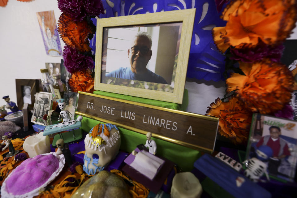A portrait of Dr. Jose Luis Linares who died from symptoms related to COVID-19, placed on a Day of the Dead altar made by his wife Rosario Martinez at their home in Mexico City, Sunday, Nov. 1, 2020. He is one of more than 1,700 Mexican health workers officially known to have died of COVID-19 who are behind honored with three days of national mourning on these Days of the Dead. (AP Photo/Eduardo Verdugo)