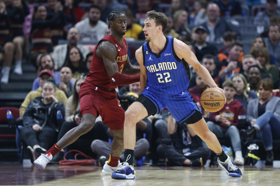 Orlando Magic forward Franz Wagner (22) plays against Cleveland Cavaliers guard Caris LeVert (3) during the first half of a NBA basketball game, Wednesday, Oct. 26, 2022, in Cleveland. (AP Photo/Ron Schwane)