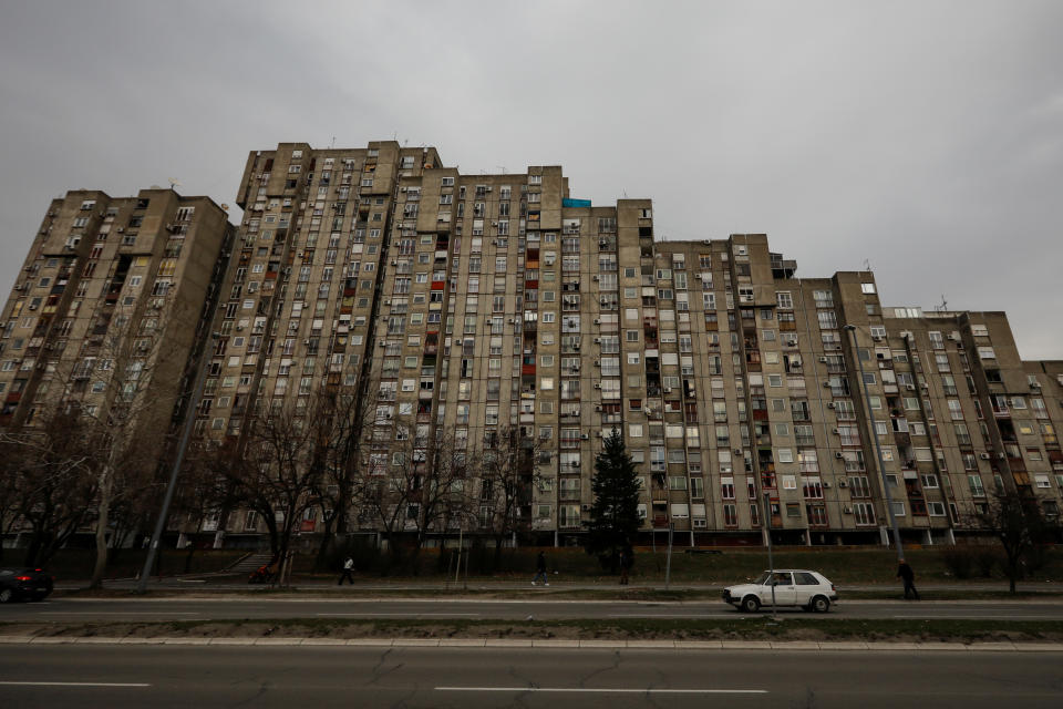 A dated Volkswagen Golf car drives past Block 61 in an apartment neighborhood in New Belgrade, Serbia. (Photo: Marko Djurica/Reuters)