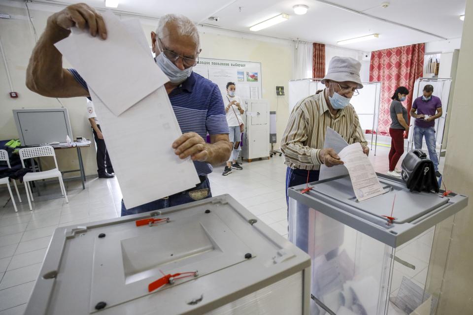 Voters cast their ballots at a polling station during the Parliamentary elections in Krymsk, Krasnodar region, Russia, Sunday, Sept. 19, 2021. The election is widely seen as an important part of President Vladimir Putin’s efforts to cement his grip on power ahead of the 2024 presidential polls, in which control of the State Duma, or parliament, will be key. (AP Photo)