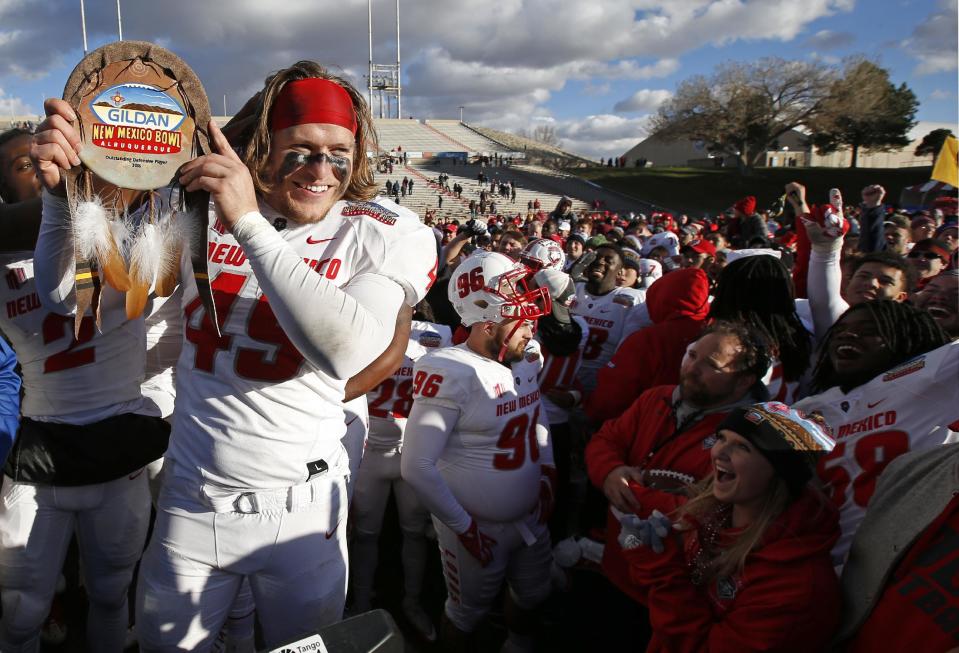 New Mexico linebacker Dakota Cox shows his trophy for outstanding defensive player after the 23-20 victory over UTSA in the New Mexico Bowl NCAA college football game in Albuquerque, N.M., Saturday, Dec. 17, 2016. (AP Photo/Andres Leighton)