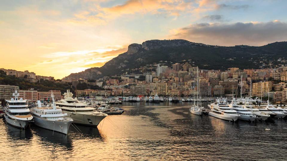 Vivid sunset over super yachts, glamorous harbour of Monaco