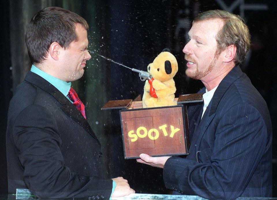 Comedian Jack Dee gets an eyeful from Sooty and puppeteer Matthew Corbett, at the launch today (Monday) of  ITV's autumn schedules. Photo by Neil Munns/PA