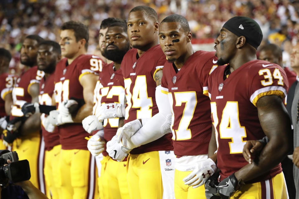 <p>Member of the Washington Redskins stand arm in arm during the playing of the National Anthem before an NFL football game against the Oakland Raiders in Landover, Md., Sept. 24, 2017. (Photo: Pablo Martinez Monsivais/AP) </p>