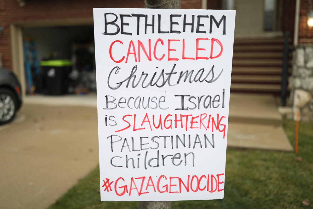 In front of their home Adam Shapiro, his son Diyaar Arraf-Shapiro, daughter Mayaar Arraf-Shapiro and wife Huwaida Arraf stand next to their nativity scene where Baby Jesus is in the middle of rubble from a collapsed building, declaring the Christmas is canceled just like it is in Bethlehem, because of the war in Gaza and the killing of Palestinian children.