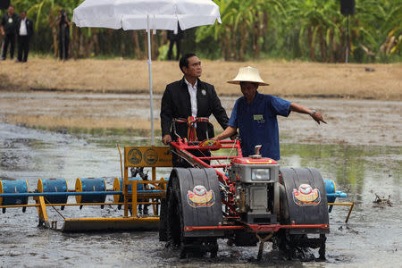 Thailand's Prime Minister Prayuth Chan-ocha rides on a tractor at a farmer school in Suphan Buri province, Thailand September 18, 2017. REUTERS/Athit Perawongmetha