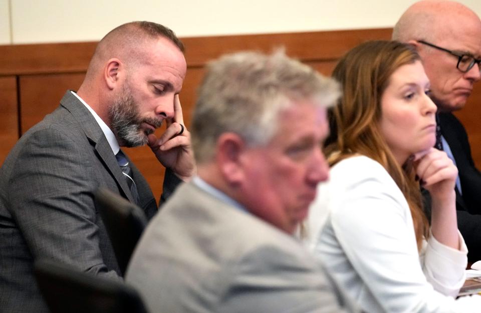Former Franklin County Sheriff's deputy Jason Meade sits with his defense attorneys while Columbus police officer Ryan Rosser testifies in the Meade's murder trial.