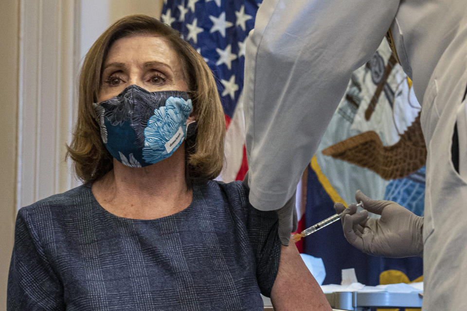 Speaker of the House Nancy Pelosi, D-Calif., receives a Pfizer-BioNTech COVID-19 vaccine shot by Dr. Brian Monahan, attending physician Congress of the United States in Washington, Friday, Dec. 18, 2020. (Ken Cedeno/Pool via AP)