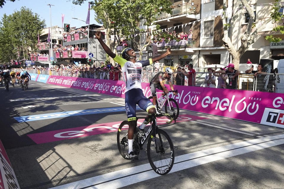 Eritrea's Biniam Girmay celebrates as he crosses the finish line of the 10th stage of the Giro D'Italia cycling race from Pescara to Jesi, Italy, Tuesday, May 17, 2022. (Massimo Paolone/LaPresse via AP)