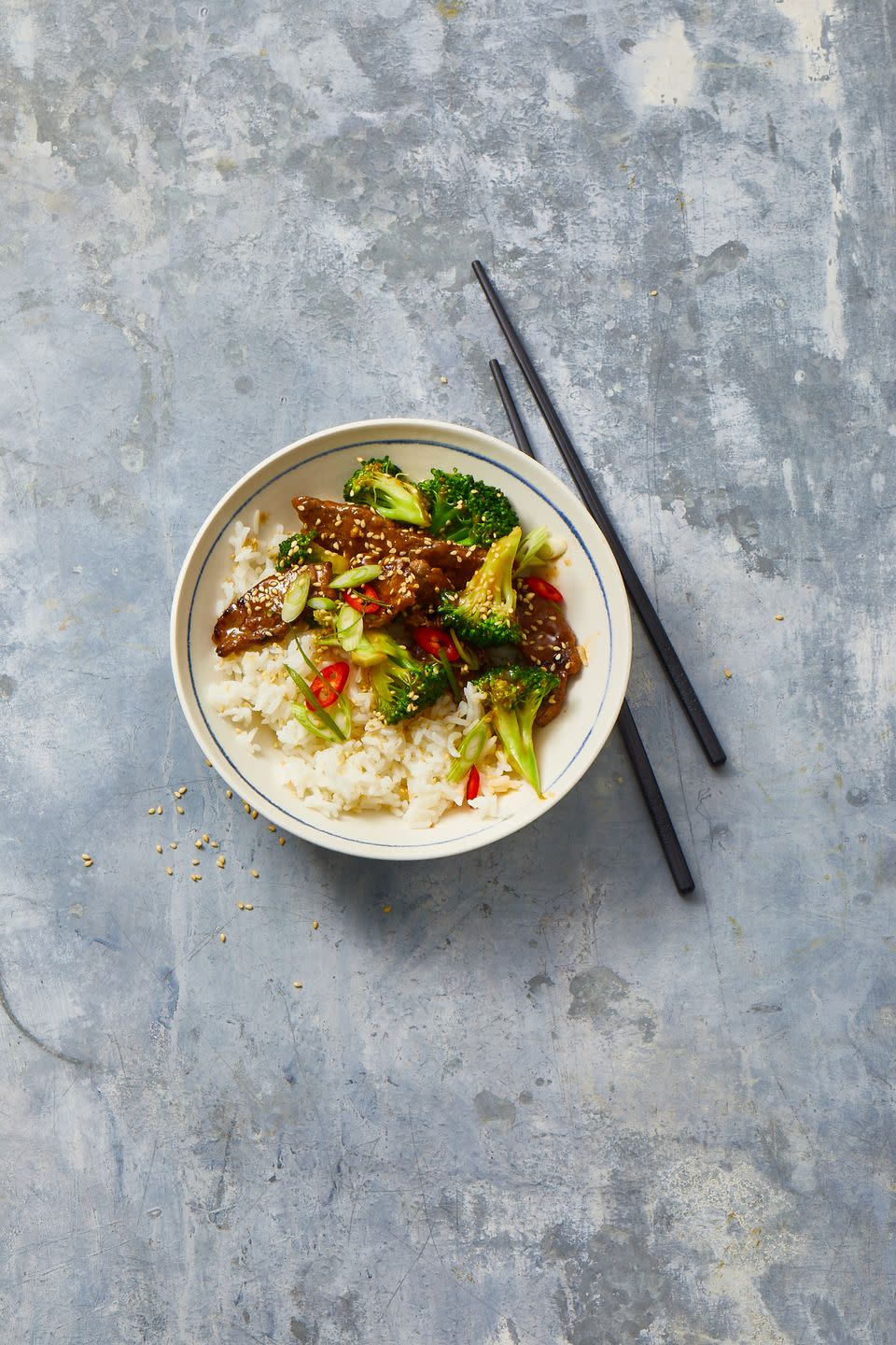 beef and broccoli with white rice in a bowl